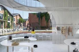 Interior of a modern retail store with white furniture, glass walls, and metal accents.