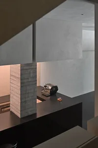 A modern coffee bar with a minimalist design, featuring a concrete counter and efficient layout.