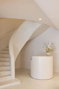Modern concrete spiral staircase with a minimalist design.