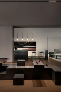 A minimalist living room featuring black metallic furniture and a large abstract painting.
