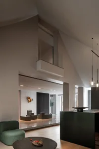 A modern living room with concrete walls, a minimalist design, and a central seating area.