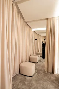 Retail clothing shop with stylish fabric curtains