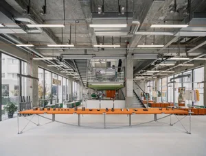 Industrial showroom with concrete, metal, and glass elements.