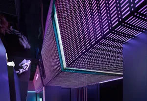 An industrial-style space exploration setting with metallic grid walls and a futuristic atmosphere.