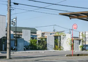 A minimalist concrete street view with modern architectural elements and greenery.