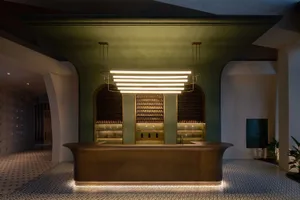 A modern bar counter crafted from ceramic, featuring sleek lines and contemporary design elements.
