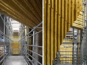 Scaffolding and construction site with metal pipes and corrugated gold panels