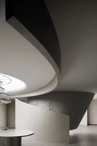 Modern interior with concrete walls and curved architectural elements.