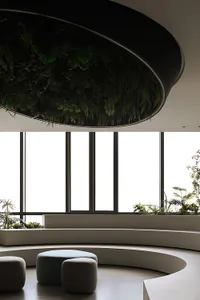 An interior space featuring a modern, minimalist design with a concrete ceiling adorned with lush green foliage and large win