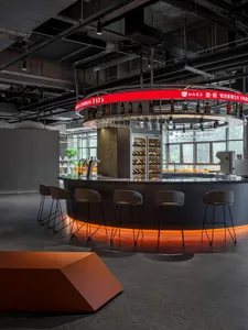 Industrial-style restaurant bar with concrete counter and glass shelves.
