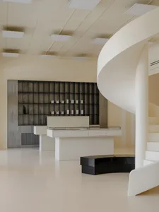 Modern retail interior space featuring concrete, glass, and metal elements.