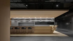 A modern commercial kitchen featuring concrete and wood materials with a minimalist design.