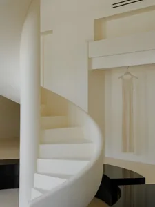 White concrete spiral staircase in a minimalist interior design