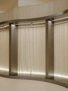 A minimalist clothing rack with a curtain.