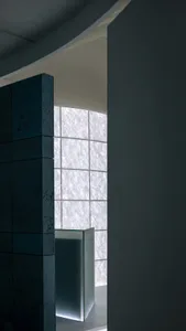 Modern bathroom with glass panel wall, featuring clean lines and contemporary design.