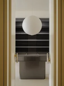 A minimalist wardrobe with metallic drawers and shelves.