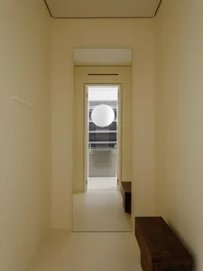 Minimalist modern interior with a white spherical pendant lamp and sleek furniture.