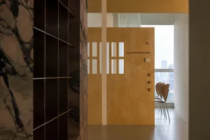 Modern office space featuring wooden paneling and chairs.