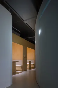 Modern restaurant interior with wooden furnishings and seating.