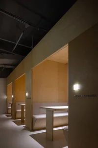 Industrial-style corporate office meeting area with wooden walls and benches