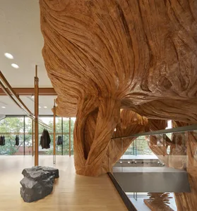 A modern lounge area featuring a large wooden art installation.