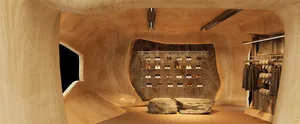 A retail store interior featuring a wooden aesthetic with a shoe display and clothing rack.