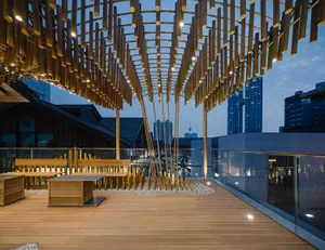 An urban rooftop retreat with wooden flooring, bamboo ceiling accents, and modern furniture.