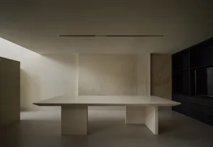 Minimalist, modern interior space featuring a large, concrete countertop.