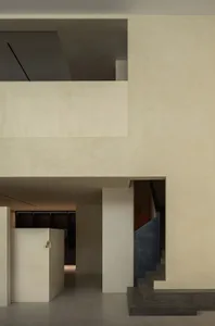 A sleek, minimalist concrete interior with open spaces and geometric forms.