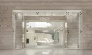 Modern, minimalist retail storefront with frameless glass doors and a contemporary interior design.