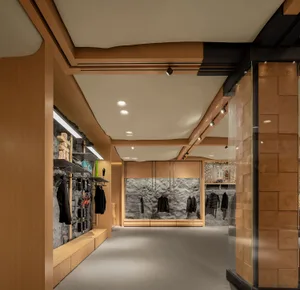 A modern retail store with wooden walls, stone accents, and minimalist design