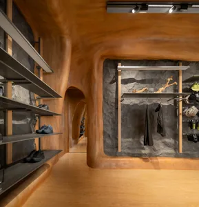 Modern retail store with wooden walls and shelves displaying shoes and accessories