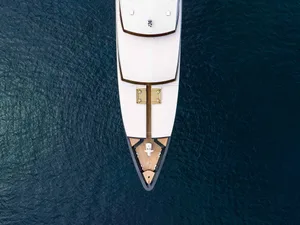 Aerial view of a white yacht looking down.