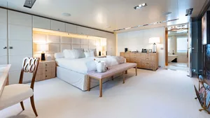 Modern, minimalist bedroom with neutral tones and contemporary fixtures.