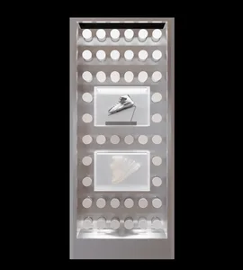 A metallic shoe shop display case with illuminated compartments and showcases.