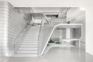 White, metal, and glass modern interior design with concrete elements