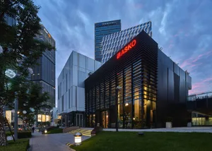 Modern office building exterior featuring metal cladding and glass.