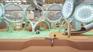 People playing in an indoor playground with plastic balls and rubber mats