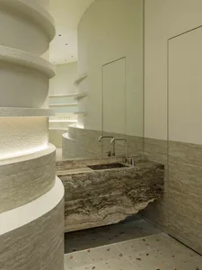 Modern bathroom design featuring sleek, curved terrazzo flooring and minimalist fixtures, creating a contemporary and luxurio
