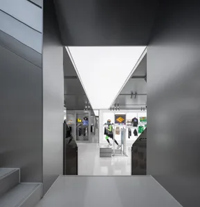 A modern retail space with minimalist design and concrete flooring.