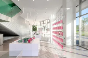 Minimalist retail space with transparent acrylic shelves and white flooring