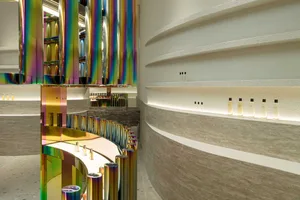 Modern retail storefront with metallic columns and concrete wall