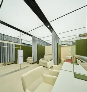 Industrial-style office interior with metal curtains, open space, and modern seating.