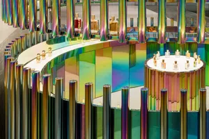 Modern retail storefront with metallic poles and colorful panels.