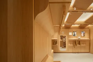 A retail space with an industrial design aesthetic, featuring wood materials and a minimalist layout.