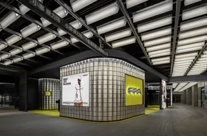 Modern industrial retail storefront featuring metallic and glass elements.