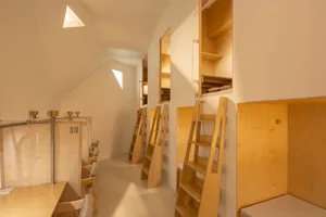 Minimalist bedroom with wooden shelves and bunk beds