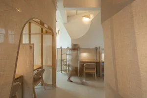 A minimalist office space with textured fabric materials.