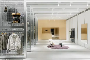 Minimalist retail storefront with metallic display shelves and wooden accents
