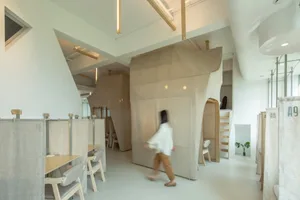 A minimalist workspace with fabric dividers and a concrete floor.